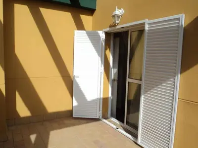 an open door with a shutter next to a building at Casa Tartessos in Costa Ballena
