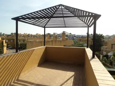 a skateboard ramp with an umbrella on a roof at Casa Tartessos in Costa Ballena
