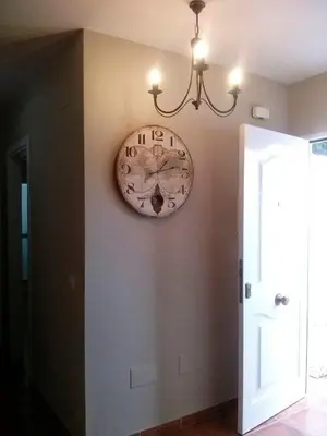 a clock hanging on a wall next to a door at Casa Tartessos in Costa Ballena