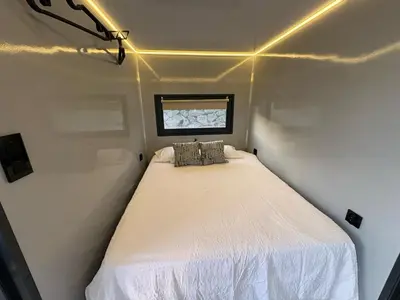 a small bed in a small room with a window at The Boathouse Company - Casa flotante experience - Real Club Náutico, El Puerto de Santa María in El Puerto de Santa María