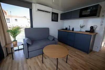 a living room with a couch and a table at The Boathouse Company - Casa flotante experience - Real Club Náutico, El Puerto de Santa María in El Puerto de Santa María
