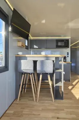 a kitchen with a table with two chairs and a counter at The Boathouse Company - Casa flotante experience - Real Club Náutico, El Puerto de Santa María in El Puerto de Santa María