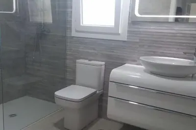 a bathroom with a toilet and a sink at Chalet en Roche - Amplio jardín in Roche