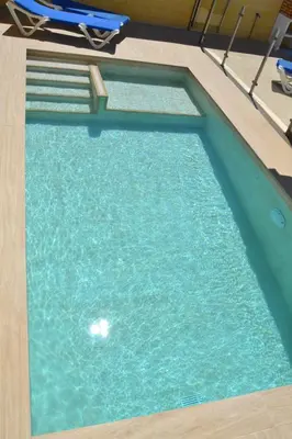 an empty swimming pool with blue water in it at CHALET SOLYMAR in Conil de la Frontera