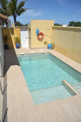 a swimming pool with a slide in a backyard at CHALET SOLYMAR in Conil de la Frontera