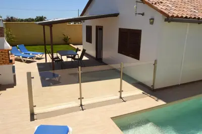 a patio with a swimming pool and a house at CHALET SOLYMAR in Conil de la Frontera