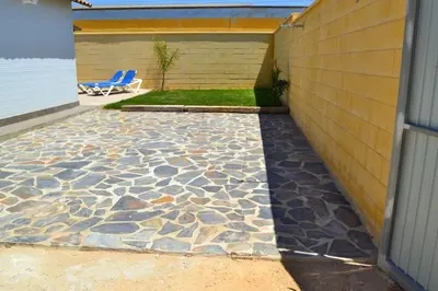 a patio with a stone floor next to a building at CHALET SOLYMAR in Conil de la Frontera
