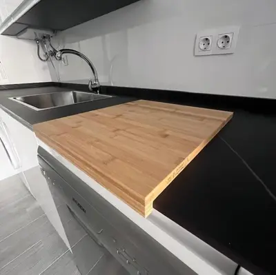 a wooden cutting board on a counter in a kitchen at piso en pleno centro in San Fernando