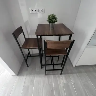 a wooden table and chairs with a potted plant on it at piso en pleno centro in San Fernando