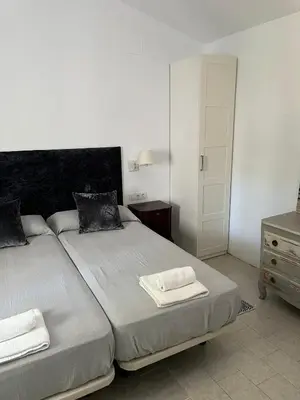 a bedroom with a bed with two towels on it at Villa America in Roche