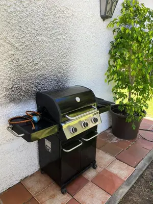 a grill sitting on a patio next to a wall at Villa America in Roche