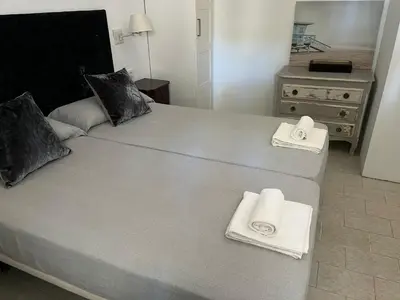 a bedroom with a large bed with towels on it at Villa America in Roche