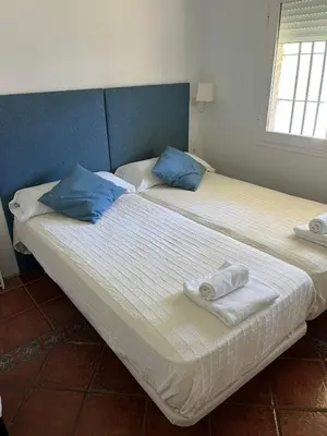 two beds sitting next to each other in a room at Villa America in Roche