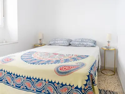 a bedroom with a bed with a colorful blanket on it at Holiday Home in Cadiz by the Sea in Cádiz