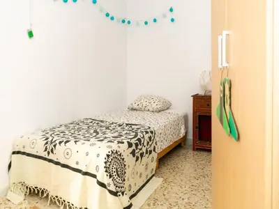 a bedroom with a bed with a black and white blanket at Holiday Home in Cadiz by the Sea in Cádiz