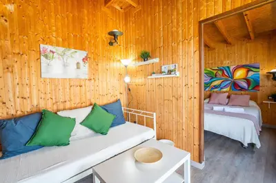 a living room with a couch in a wooden room at El Paraíso Perdido in Conil de la Frontera