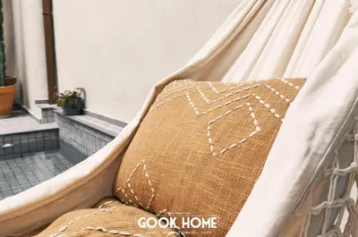 a bed with a pillow in a hammock at LalaSuites ARENAL in Jerez de la Frontera