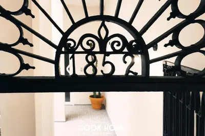 a stairway with a black wrought iron railing at LalaSuites ARENAL in Jerez de la Frontera
