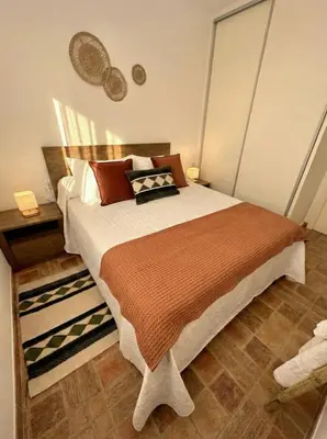 a bedroom with a large bed in a room at Encanto Jerezano Hideaway - Apartamento en Jerez - Apartment in Sherry in Jerez de la Frontera