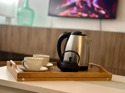 a coffee maker and two cups on a wooden tray at Encanto Jerezano Hideaway - Apartamento en Jerez - Apartment in Sherry in Jerez de la Frontera