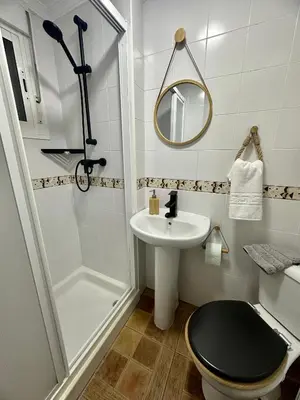 a bathroom with a sink and a toilet and a shower at Encanto Jerezano Hideaway - Apartamento en Jerez - Apartment in Sherry in Jerez de la Frontera