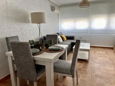 a dining room table with chairs and a couch at Encanto Jerezano Hideaway - Apartamento en Jerez - Apartment in Sherry in Jerez de la Frontera