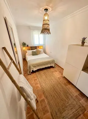 a bedroom with two beds and a chandelier at Encanto Jerezano Hideaway - Apartamento en Jerez - Apartment in Sherry in Jerez de la Frontera