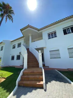 a house with stairs in front of it at Apartamento pinar del atlántico in Chiclana de la Frontera