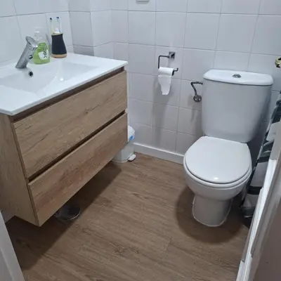 a bathroom with a white toilet and a sink at Apartamento pinar del atlántico in Chiclana de la Frontera