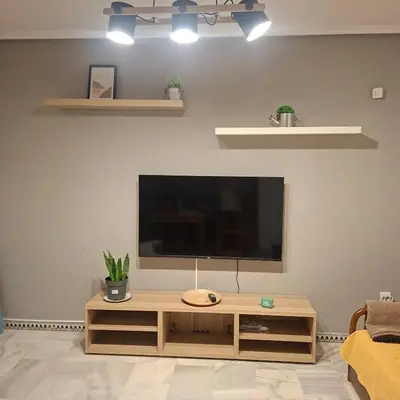 a living room with a flat screen tv on a wall at Apartamento pinar del atlántico in Chiclana de la Frontera