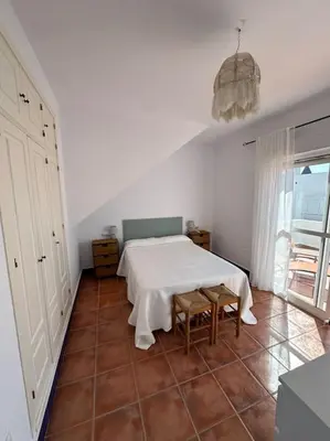 a white room with a table and two chairs at Adosado La Loma en Novo Sancti Petri in Chiclana de la Frontera