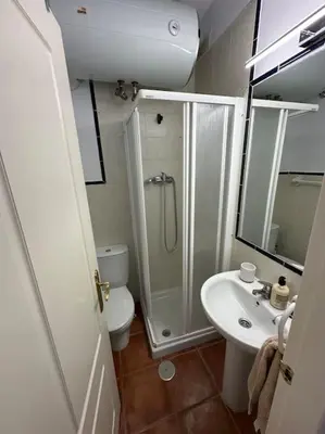 a bathroom with a shower and a toilet and a sink at Adosado La Loma en Novo Sancti Petri in Chiclana de la Frontera
