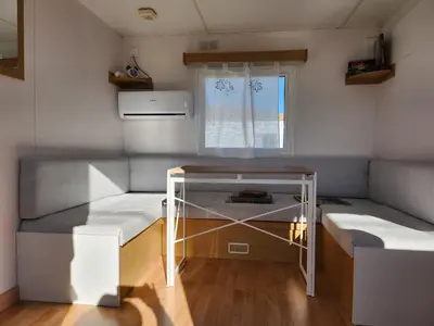 a small room with two beds and a window at Franceses in Chiclana de la Frontera