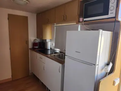 a kitchen with a white refrigerator and a microwave at Franceses in Chiclana de la Frontera