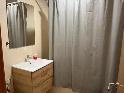 a bathroom with a sink and a shower curtain at Disfruta Jerez in Jerez de la Frontera