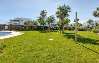 a park with palm trees and a pool at Gorgeous Apartment In Rota With Wifi in Rota