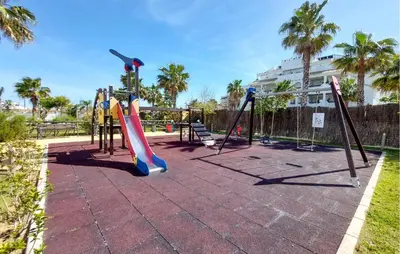 a playground with slides and swings at Gorgeous Apartment In Rota With Wifi in Rota