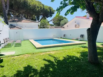 a pool in the backyard of a house at Marisma Home in Chiclana de la Frontera