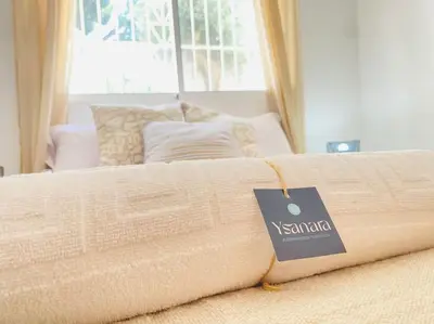 a bed with a sign on top of it at Marisma Home in Chiclana de la Frontera