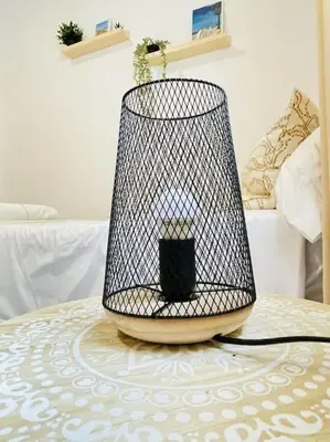 a black bird cage sitting on top of a table at Marisma Home in Chiclana de la Frontera