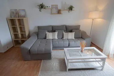 a living room with a gray couch and a coffee table at GINVA - Apartamento en pleno centro 2 in El Puerto de Santa María