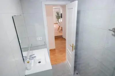 a white bathroom with a shower and a sink at GINVA - Apartamento en pleno centro 2 in El Puerto de Santa María