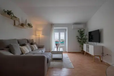 a living room with a couch and a tv at GINVA - Apartamento en pleno centro 2 in El Puerto de Santa María