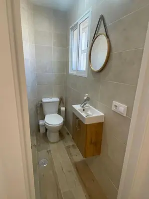 a bathroom with a toilet and a sink and a mirror at Coqueto Mini piso / Estudio/ 20 metros / playa / Wifi in Chiclana de la Frontera