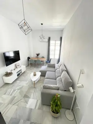a living room with a couch and a table at Dublin apartment in El Puerto in El Puerto de Santa María