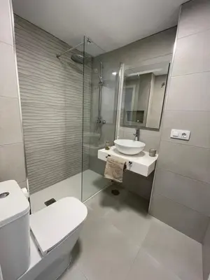 a bathroom with a toilet and a sink and a shower at Dublin apartment in El Puerto in El Puerto de Santa María