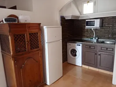 a kitchen with a white refrigerator and a microwave at Apartamentos Jasmund - Estudio 02 in San Fernando