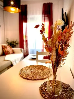 a vase with flowers in it on a table at MyChoice Casa Lilia in Rota
