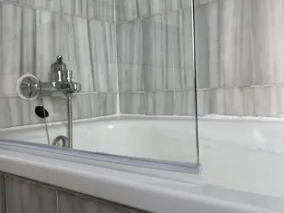 a white bath tub with a shower curtain and a glass window at Jerez Avenida in Jerez de la Frontera