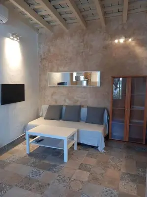 a living room with a couch and a table at Casa Florinda #5 in Jerez de la Frontera
